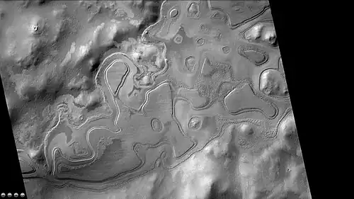 Layers just outside rim of western side of South crater in the form of "Swiss cheese," as seen by CTX camera.  Note: this is an enlargement of a previous image of west side of South crater.