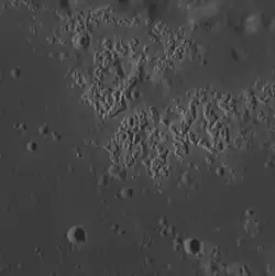 Hollows in Zeami crater.  Image width is about 23.2 km.