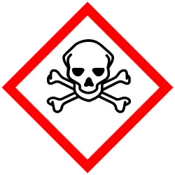 A hazard symbol depicting a human skull in front of two bones crossing between one another.