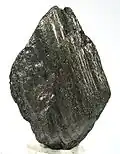 A black multi-layered lozenge-shaped rock