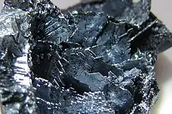 Shiny violet-black colored crystalline shards.