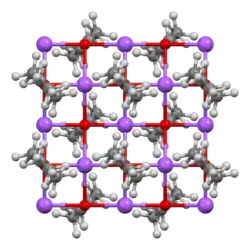 Profile of stone face on mountainside, with 3 workers.