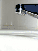 B. Water dripping from a tap