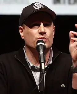 Kevin Feige speaking into a microphone at the 2013 San Diego Comic-Con