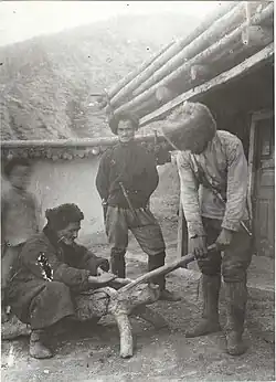 Men at work on a wooden tanning drum, Dzheyrakh village 1921