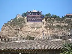 Nanhua Amituo Fo Temple of Chinese Buddhism seen on a hill above the roofs of the Yu Baba Gongbei, a Sufi shrine.