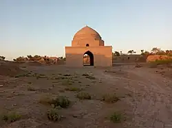  A photo of a small mosque surrounded by desert