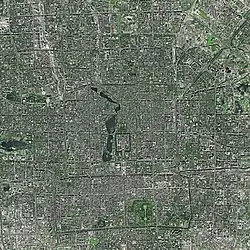 Satellite image of the city of Beijing, with the Forbidden City in the center, just north of Tiananmen Square and east of a string of lakes.  Also visible are Yuyuantan lake in the west and the southern city moat, which once surrounded the walled outer city.