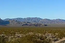 Valley's center-south, from east side.(North end of Highland Range (from east-southeast), McCullough Range massif beyond.)