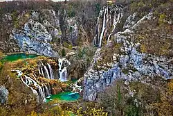 Two greenish-blue lakes in a forest