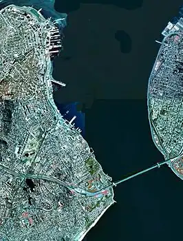A satellite view of The Narrows with Staten Island (on the west /  left) and Brooklyn / Long Island (on the east / right) connected by the prominent landmark Verrazzano-Narrows Bridge