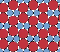 In work dedicated to Fejes Tóth, this compact binary circle packing was shown to be the densest possible planar packing of discs with this size ratio.