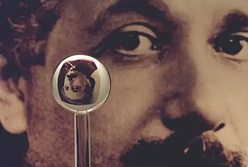 An image of one of the most accurate human-made spheres, as it refracts the image of Einstein in the background. This sphere was a fused quartz gyroscope for the Gravity Probe B experiment, and differs in shape from a perfect sphere by no more than 40 atoms (less than 10 nm) of thickness. It was announced on 1 July 2008 that Australian scientists had created even more nearly perfect spheres, accurate to 0.3 nm, as part of an international hunt to find a new global standard kilogram.