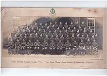Formal picture of approx 50 males in Army Uniform, front row seated, with the officers, then 4 rows standing probably on benches or staging, about 15 per row, presumably of dentists who were passing out following completion of the course