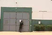 A guard shuts a prison door.