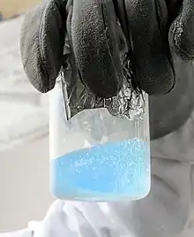 A pale blue liquid, with visible boiling