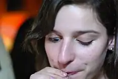 Marcus Gunn phenomenon: the woman cannot control her eyelids while drinking. This is a particularly mild case.}