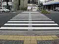 Low-profile directional tactile markings are installed on busy pedestrian crossings in Japan.