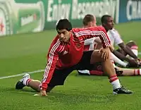 Football player Luis Suárez stretching prior to a match.