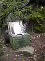 This pit latrine, located near a remote wilderness cabin in Nova Scotia, Canada, has a thunderbox over the pit -- essentially an open-bottom box with a seat on the lid -- instead of an outhouse.