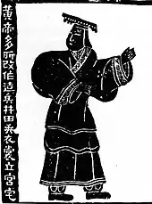 A stylized black and white Chinese artwork of the Yellow Emperor, with Chinese script at left