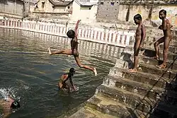 Boys skinny dipping in a sacred tank in Tiruvanamalai, India (2006)