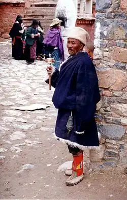 Pilgrim with prayer wheel, Tsurphu Monastery, 1993