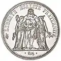 Piesă cu valoarea nominală de 5 franci, emisă în 1967, argint, 37 mm diametru, 25 grame; avers: circular: LIBERTE EGALITE FRATERNITE; în centru, Hercule având în stânga saJustitia, iar în dreapta sa Republica; în exergă, semnătura artistului gravor Augustin Dupré