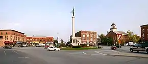 Downtown Angola's traffic circle (or roundabout-- nicknamed "The Mound"), looking east.  The monument in the center is dedicated to those who served in the American Civil War.  The building with the cupola is the Steuben County courthouse, which is on the National Register of Historic Places.