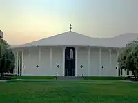 Photo of a  circular building surrounded by grass.