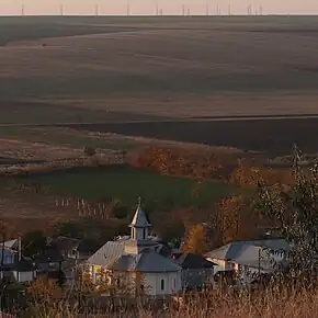 Biserica ”Sfânta Parascheva” văzută de pe dealurile satului