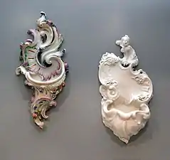 Două fonturi de apă sfințită, făcute din porțelan de Nymphenburg holy water fonts, modele probabil de Franz Anton Bustelli (în jur de 1760)