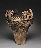 Vas în „stilul cu flăcări”; din perioada Jōmon a Japoniei; c. 2750 î.Hr.; ceramică cu ornamente decorate și aplicate; înălțime: 61&nbsp;cm, diametru: 55,8&nbsp;cm; Muzeul de Artă din Cleveland