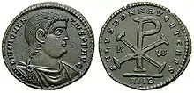 Monograma lui Iisus Hristos pe o monedă romană emisă sub Magnentius (350-353) AD. Æ Dublu Centenionalis (8,88 grame); avers: D N MAGNEN-TIVS P F AVG, bust drapat și cu armură spre dreapta; revers: SALVS DD NN AVG ET CAES, Α-Ω, Monograma lui Isus Cristos; în exergă: AMB (marca monetăriei din Ambianum (Amiens)).