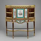 Secretair în stilul Ludovic al XVI-lea (secrétaire à abattant or secrétaire en cabinet); circa 1776; stejar furniruit cu lemn de lalea și amarant, șase plăci de porțelan Sèvres și multe alte materiale; 110,1 x 102,9 x 32,7 cm; Muzeul Metropolitan de Artă