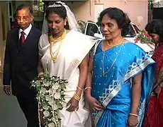 Mireasă creștină malaeziană îmbrăcată într-un sari alb