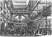 Interior din Le Bon Marché (Paris), cu scări asemănătoare cu cele ale Opérei Garnier a lui Charles Garnier, 1872-1874, de Louis-Charles Boileau în colaborare cu firma de inginerie a lui Gustave Eiffel