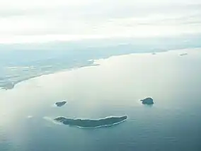 O vedere aeriană a insulelor Mamutik (stânga sus), Sulug (dreapta sus) și Manukan (jos) care seamănă cu o față zâmbitoare.