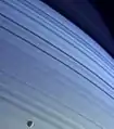 Mimas, silhouetted against Saturn's northern latitudes.