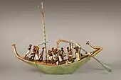 Model de barcă; 1981–1975 î.Hr.; lemn vopsit, ipsos, sfoară de in și țesătură de in; lungime: 145 cm;  Muzeul Metropolitan de Artă