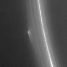 A bright narrow band runs from the top to bottom. To the right of it in the diffuse halo the is a bright small object.