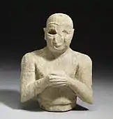 Parte a unei statui a unui închinător; 2500-2250 BC; alabastru-calcit; înălțime: 19,5&nbsp;cm, lățime: 13,3&nbsp;cm, adâncime: 10&nbsp;cm; Muzeul de Artă Walters (Baltimore, SUA)