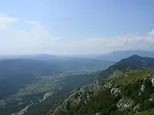 A photo showing a valley and a mountain