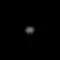 A blurry ellipsoidal object in the center of the image