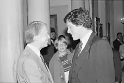 A monochrome image of Carter shaking hands with Bill Clinton