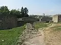 Zidul de pe latura de sud, datând din vremea lui Alexandru cel Bun și un zid perpendicular pe acesta, datând din vremea lui Ștefan cel Mare