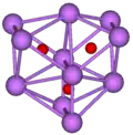  The stick and ball diagram shows three regular octahedra which are connected to the next one by one surface and the last one shares one surface with the first. All three have one edge in common. All eleven vertices are purple spheres representing caesium, and at the center of each octahedron is a small red sphere representing oxygen.