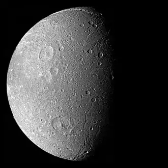 Dione as seen by Voyager 1; the craters prominent at upper and lower left are Dido and Aeneas; to the latter's right are the troughs Latium and Larissa chasmata.