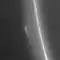 A bright narrow band runs from the top to bottom. To the right of it in the diffuse halo the is a bright small object.