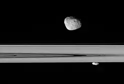 Janus and Prometheus lie above and below Saturn's rings (2006-04-29).